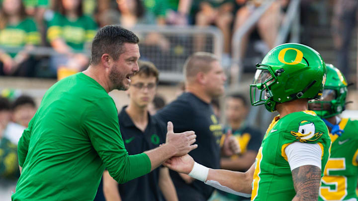 Oregon coach Dan Lanning celebrates with quarterback Dillon Gabriel during warmups before the game against Boise State at Autzen in Eugene Sept. 7, 2024.