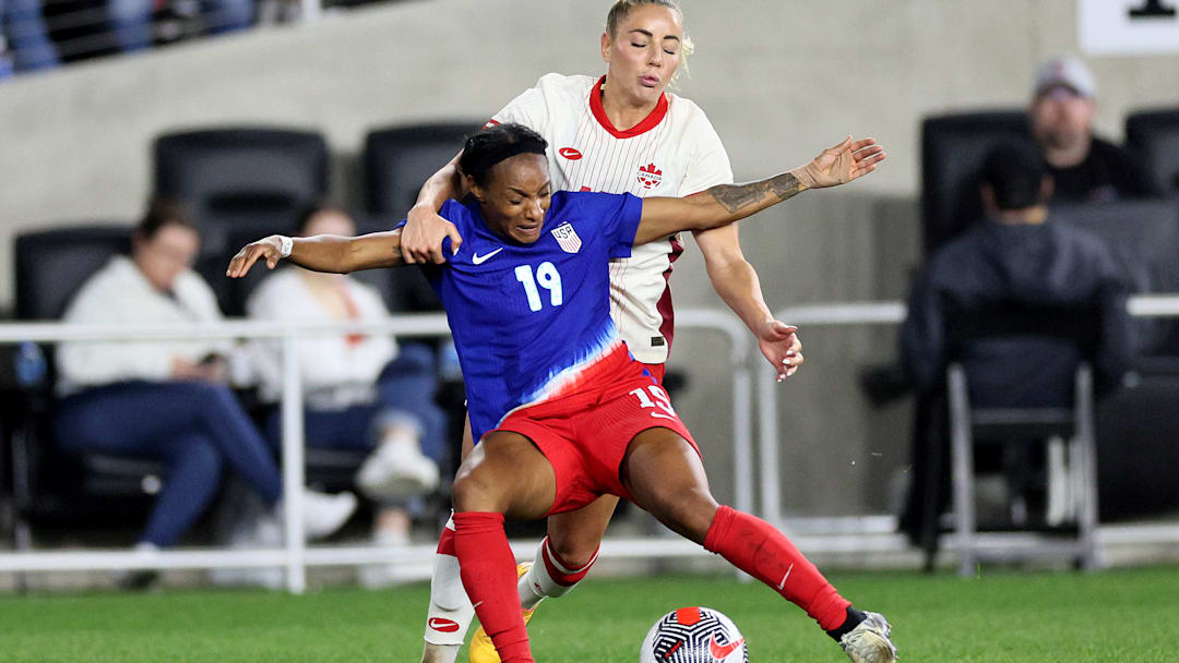 Crystal Dunn and Adriana Leon battle for the ball during a USWNT vs Canada game during the 2024 SheBelieves Cup.