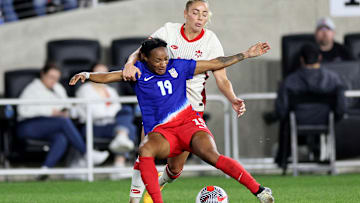Crystal Dunn and Adriana Leon battle for the ball during a USWNT vs Canada game during the 2024 SheBelieves Cup.
