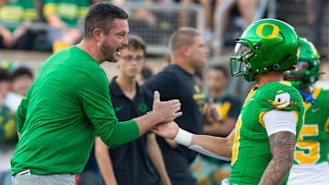 Oregon coach Dan Lanning celebrates with quarterback Dillon Gabriel during warmups before the game against Boise State at Autzen in Eugene Sept. 7, 2024.