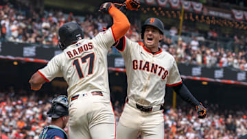Apr 6, 2025; San Francisco, California, USA; San Francisco Giants designated hitter Heliot Ramos (17) gives for arm bashes toSan Francisco Giants right fielder Mike Yastrzemski (5) for the three run home against the Seattle Mariners during the fourth inning at Oracle Park. 