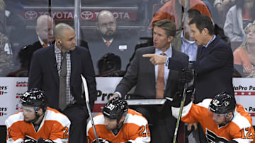 Oct 29, 2015; Philadelphia, PA, USA; Philadelphia Flyers assistant coach Ian Laperriere, head coach Dave Hakstol  and assistant coach Gord Murphy behind the bench against the New Jersey Devils during the third period at Wells Fargo Center. The Devils defeated the Flyers, 4-1.