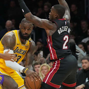 Dec 4, 2024; Miami, Florida, USA;  Los Angeles Lakers forward LeBron James (23) looks to pass the ball as Miami Heat guard Terry Rozier (2) defends in the second half at Kaseya Center. Mandatory Credit: Jim Rassol-Imagn Images