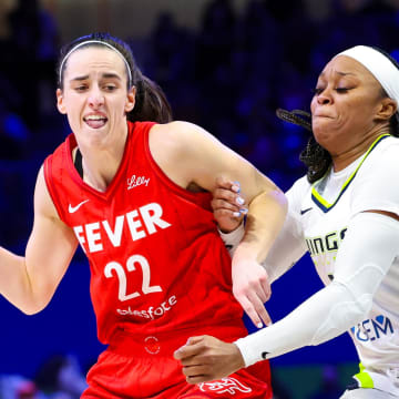 Jul 17, 2024; Arlington, Texas, USA; Indiana Fever guard Caitlin Clark (22) dribbles as Dallas Wings guard Odyssey Sims (2) defends  during the second half at College Park Center. Mandatory Credit: Kevin Jairaj-USA TODAY Sports