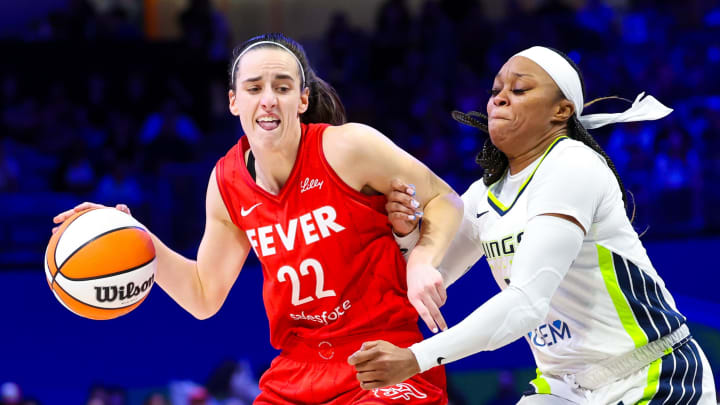 Jul 17, 2024; Arlington, Texas, USA; Indiana Fever guard Caitlin Clark (22) dribbles as Dallas Wings guard Odyssey Sims (2) defends  during the second half at College Park Center. Mandatory Credit: Kevin Jairaj-USA TODAY Sports