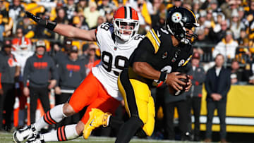 Dec 8, 2024; Pittsburgh, Pennsylvania, USA;  Cleveland Browns defensive end Cameron Thomas (99) chases Pittsburgh Steelers quarterback Russell Wilson (3) during the third quarter at Acrisure Stadium.