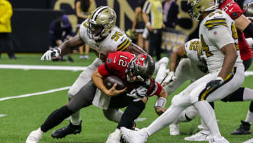 Oct 31, 2021; New Orleans, LA; Tampa Bay Buccaneers quarterback Tom Brady (12) is sacked by New Orleans Saints defensive end Tanoh Kpassagnon (90).