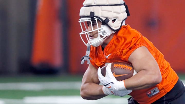 Oklahoma State's Sesi Vailahi runs with the ball during an Oklahoma State spring football practice