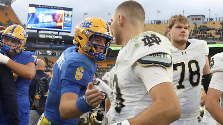 Nov 15, 2025; Pittsburgh, Pennsylvania, USA;  Pittsburgh Panthers quarterback Mason Heintschel (6) and Notre Dame Fighting Irish quarterback CJ Carr (13) shake hands after their game at Acrisure Stadium. Mandatory Credit: Charles LeClaire-Imagn Images