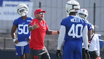 Bills defensive coordinator Bobby Babich talks with Von Miller and the defense
