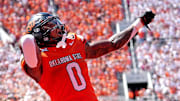 Oklahoma State's Ollie Gordon II (0) celebrates in the second half of the college football game between the Oklahoma State Cowboys and the Arkansas Razorbacks at Boone Pickens Stadium in Stillwater, Okla.,, Saturday, Sept., 7, 2024.