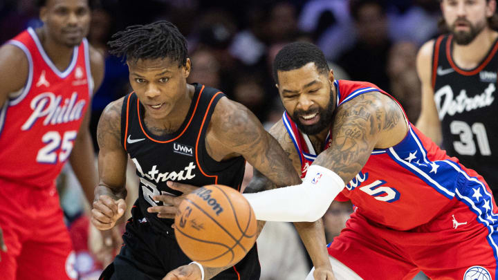 Dec 15, 2023; Philadelphia, Pennsylvania, USA; Detroit Pistons guard Marcus Sasser (25) and Philadelphia 76ers forward Marcus Morris Sr. (5) compete for a loose ball during the fourth quarter at Wells Fargo Center. Mandatory Credit: Bill Streicher-USA TODAY Sports