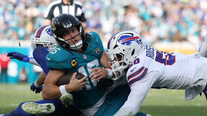 Jan 11, 2026; Jacksonville, FL, USA; Jacksonville Jaguars quarterback Trevor Lawrence (16) is tackled by Buffalo Bills defensive end Greg Rousseau (50) during the second half in an AFC Wild Card Round game at EverBank Stadium. Mandatory Credit: Nathan Ray Seebeck-Imagn Images