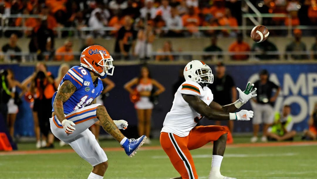 Aug 24, 2019; Orlando, FL, USA; Miami Hurricanes safety Amari Carter (5) intercepts a pass intended for Florida Gators wide receiver Freddie Swain (16) during the second half at Camping World Stadium. Mandatory Credit: Jasen Vinlove-USA TODAY Sports