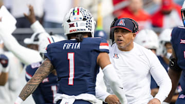 Nov 22, 2025; Tucson, Arizona, USA; Arizona Wildcats wide receivers coach Bobby Wade celebrates a play with quarterback Noah Fifita (1) against the Baylor Bears at Casino Del Sol Stadium. Mandatory Credit: Mark J. Rebilas-Imagn Images
