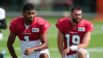 Aug 2, 2022; Miami Gardens, Florida, US; Miami Dolphins quarterback Tua Tagovailoa (1) and quarterback Skylar Thompson (19) stretch during training camp at Baptist Health Training Complex. Mandatory Credit: Jasen Vinlove-Imagn Images