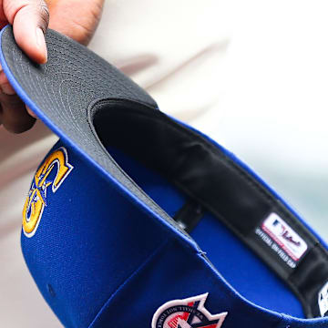 A member of the Seattle Mariners holds a hat before a game against the Atlanta Braves on Sept. 11, 2022, at T-Mobile Park.