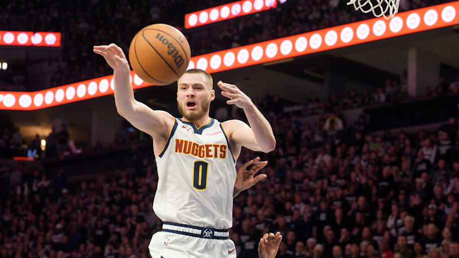 Denver Nuggets guard Christian Braun passes the ball against the Minnesota Timberwolves.