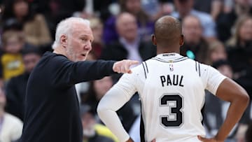 San Antonio Spurs head coach Gregg Popovich speaks with guard Chris Paul during the second quarter of an NBA game