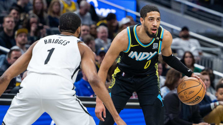 Mar 16, 2024; Indianapolis, Indiana, USA;  Indiana Pacers guard Tyrese Haliburton (0) dribbles the ball while Brooklyn Nets forward Mikal Bridges (1) defends in the first half at Gainbridge Fieldhouse. Mandatory Credit: Trevor Ruszkowski-USA TODAY Sports