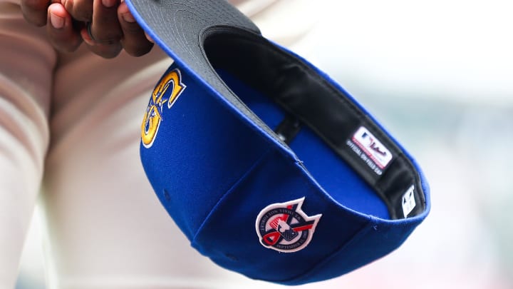 A member of the Seattle Mariners holds a baseball hat before the game against the Atlanta Braves at T-Mobile Park. 