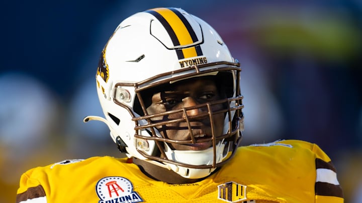 Dec 30, 2022; Tucson, AZ, USA; Wyoming Cowboys guard Emmanuel Pregnon (76) against the Ohio Bobcats during the 2022 Barstool Sports Arizona Bowl at Arizona Stadium. Mandatory Credit: Mark J. Rebilas-Imagn Images