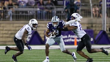 Oct 21, 2023; Manhattan, Kansas, USA; Kansas State Wildcats wide receiver Phillip Brooks (8) tries to run by TCU Horned Frogs safety Millard Bradford (28) and safety Bud Clark (21) during the fourth quarter at Bill Snyder Family Football Stadium. Mandatory Credit: Scott Sewell-Imagn Images