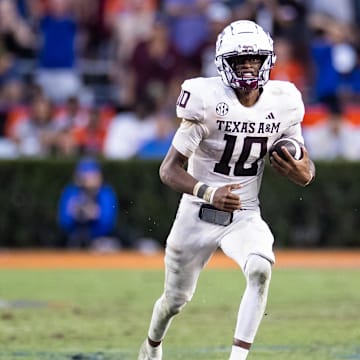 Sep 14, 2024; Gainesville, Florida, USA; Texas A&M Aggies quarterback Marcel Reed (10) runs with the ball against the Florida Gators during the second half at Ben Hill Griffin Stadium. Mandatory Credit: Matt Pendleton-Imagn Images