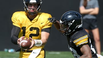 Iowa quarterback Cade McNamara (12) hands the ball off to Kamari Moulton (28) during Kids Day at Kinnick Saturday, Aug. 10, 2024 at Kinnick Stadium in Iowa City, Iowa.