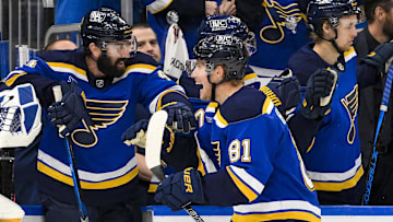 Mar 20, 2025; St. Louis, Missouri, USA;  St. Louis Blues center Dylan Holloway (81) is congratulated by defenseman Nick Leddy (4) after scoring against the Vancouver Canucks during the third period at Enterprise Center. Mandatory Credit: Jeff Curry-Imagn Images
