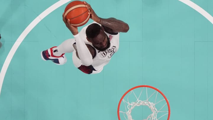 Jul 31, 2024; Villeneuve-d'Ascq, France; United States guard Lebron James (6) dunks against South Sudan small forward Nuni Omot (5) in the fourth quarter during the Paris 2024 Olympic Summer Games at Stade Pierre-Mauroy. Mandatory Credit: John David Mercer-USA TODAY Sports