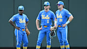 Jun 17, 2025; Omaha, Neb, USA;  UCLA Bruins left fielder Dean West (36) and center fielder Payton Brennan (11) and right fielder A.J. Salgado (24) wait out a pitching change against the LSU Tigers during the fourth inning at Charles Schwab Field. Mandatory Credit: Steven Branscombe-Imagn Images
