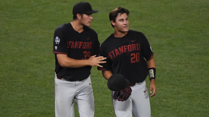 Jun 23, 2021; Omaha, Nebraska, USA; Stanford Cardinal pitcher Jacob Palisch (39) consoles losing pitcher Brendan Beck (20) after the game against the Vanderbilt Commodores  at TD Ameritrade Park. Mandatory Credit: Steven Branscombe-Imagn Images