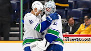 Jan 29, 2025; Nashville, Tennessee, USA;  Vancouver Canucks center Dakota Joshua (81) congratulates goaltender Thatcher Demko (35) on the win against the Nashville Predators during the third period at Bridgestone Arena. Mandatory Credit: Steve Roberts-Imagn Images