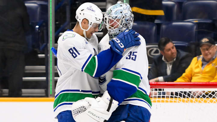 Jan 29, 2025; Nashville, Tennessee, USA;  Vancouver Canucks center Dakota Joshua (81) congratulates goaltender Thatcher Demko (35) on the win against the Nashville Predators during the third period at Bridgestone Arena. Mandatory Credit: Steve Roberts-Imagn Images