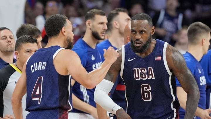 Jul 28, 2024; Villeneuve-d'Ascq, France; United States guard Lebron James (6) and shooting guard Stephen Curry (4) celebrate after a play  in the third quarter against Serbia during the Paris 2024 Olympic Summer Games at Stade Pierre-Mauroy. Mandatory Credit: John David Mercer-USA TODAY Sports