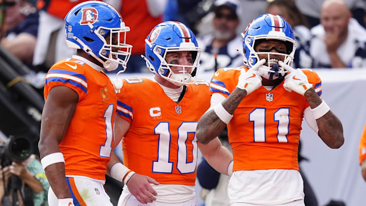 Oct 26, 2025; Denver, Colorado, USA;  Denver Broncos wide receiver Troy Franklin (11) celebrates with wide receiver Courtland Sutton (14) and quarterback Bo Nix (10) after scoring a touchdown against the Dallas Cowboys in the fourth quarter at Empower Field at Mile High. 