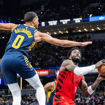 Nov 27, 2023; Indianapolis, Indiana, USA; Portland Trail Blazers center Deandre Ayton (2) shoots the ball while Indiana Pacers guard Tyrese Haliburton (0) defends in the second quarter at Gainbridge Fieldhouse. Mandatory Credit: Trevor Ruszkowski-Imagn Images
