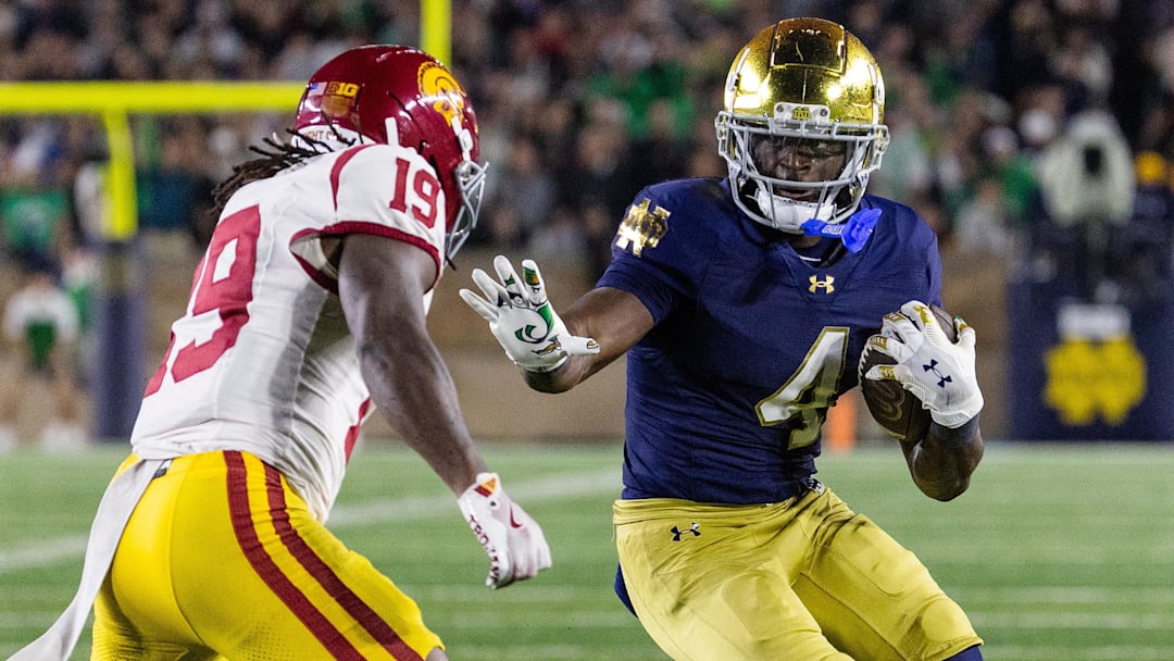 Notre Dame running back Jeremiyah Love runs with the ball against USC safety Bishop Fitzgerald during their game this season.