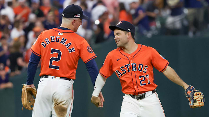 Houston Astros third baseman Alex Bregman high fives second baseman Jose Altuve after a win. Houston Astros third baseman Alex Bregman high fives second baseman Jose Altuve after a win.