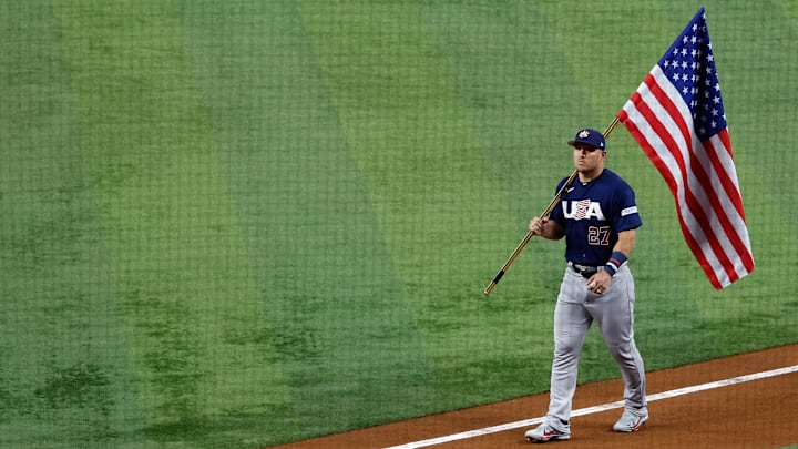Mar 21, 2023; Miami, Florida, USA; USA center fielder Mike Trout (27) carries the American flag Mar 21, 2023; Miami, Florida, USA; USA center fielder Mike Trout (27) carries the American flag