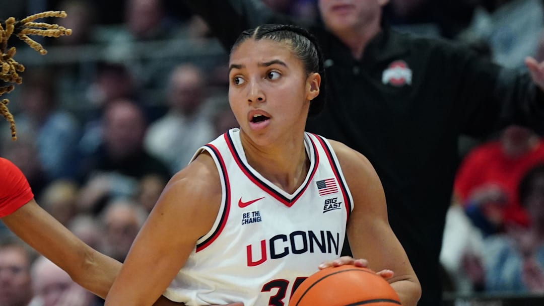 Nov 16, 2025; Hartford, Connecticut, USA; UConn Huskies guard Azzi Fudd (35) drives the ball against Ohio State Buckeyes guard Jaloni Cambridge (22) in the first half at Peoples Bank Arena. Mandatory Credit: David Butler II-Imagn Images