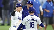 Los Angeles Dodgers designated hitter Shohei Ohtani (17) celebrates with pitcher Roki Sasaki (11) and pitcher Yoshinobu Yamamoto (18) after winning in the eighteenth inning against the Toronto Blue Jays in game three of the 2025 MLB World Series on Oct. 27.