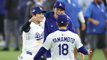 Los Angeles Dodgers designated hitter Shohei Ohtani (17) celebrates with pitcher Roki Sasaki (11) and pitcher Yoshinobu Yamamoto (18) after winning in the eighteenth inning against the Toronto Blue Jays in game three of the 2025 MLB World Series on Oct. 27.