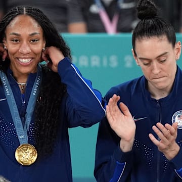 Aug 11, 2024; Paris, France; United States forward A'Ja Wilson (9) celebrates on the podium after defeating France in the women’s basketball gold medal game during the Paris 2024 Olympic Summer Games at Accor Arena. Mandatory Credit: James Lang-Imagn Images