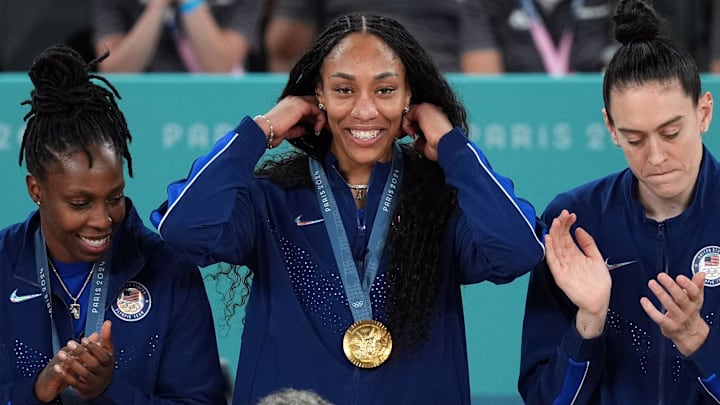 Aug 11, 2024; Paris, France; United States forward A'Ja Wilson (9) celebrates on the podium after defeating France in the women’s basketball gold medal game during the Paris 2024 Olympic Summer Games at Accor Arena. Mandatory Credit: James Lang-Imagn Images