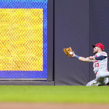 Sep 4, 2024; Milwaukee, Wisconsin, USA;  St. Louis Cardinals center fielder Michael Siani (63) slides while trying to catch the ball hit by Milwaukee Brewers second baseman Brice Turang (2) (not pictured) during the third inning at American Family Field. Mandatory Credit: Jeff Hanisch-Imagn Images