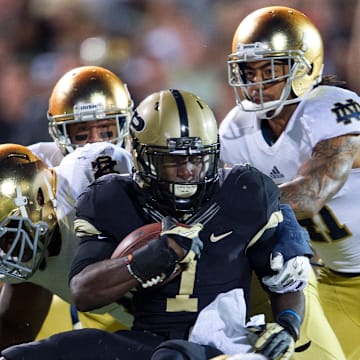 Sep 14, 2013; West Lafayette, IN, USA; Purdue Boilermakers running back Akeem Hunt (1) is tackled by Notre Dame Fighting Irish linebacker Dan Fox (48)  and nose tackle Louis Nix (1) in the third quarter at Ross-Ade Stadium. Notre Dame won 31-24. 