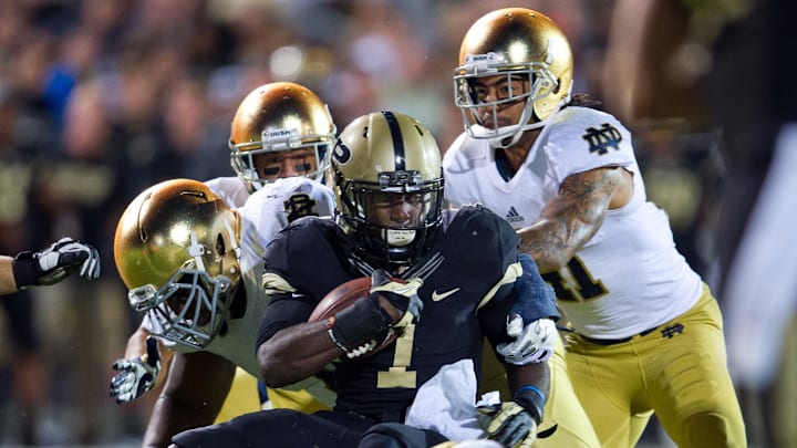 Sep 14, 2013; West Lafayette, IN, USA; Purdue Boilermakers running back Akeem Hunt (1) is tackled by Notre Dame Fighting Irish linebacker Dan Fox (48)  and nose tackle Louis Nix (1) in the third quarter at Ross-Ade Stadium. Notre Dame won 31-24. 