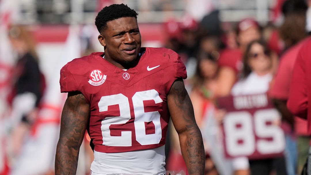 Nov 22, 2025; Tuscaloosa, Alabama, USA; Alabama running back Jam Miller (26) walks to his family with a rose in hand on Senior Day at Saban Field at Bryant-Denny Stadium.